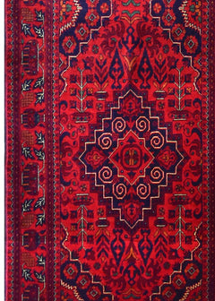 An Afghan Biljik runner featuring a deep red background with intricate blue geometric patterns.