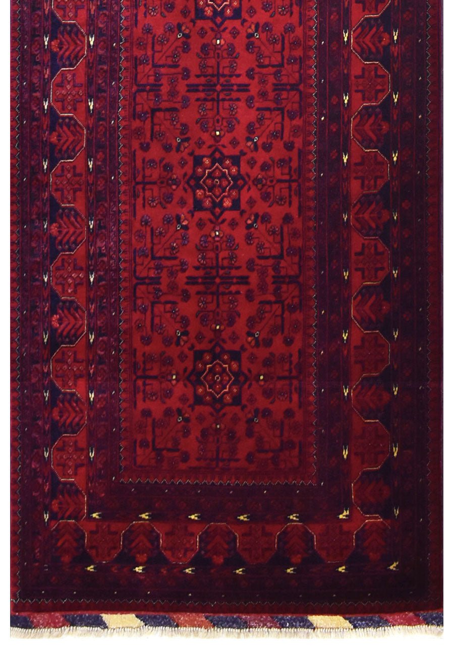 A handmade Afghan Biljik runner featuring deep red tones and intricate blue geometric patterns.