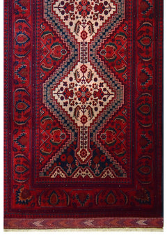 Handmade Afghan Biljik runner featuring a geometric pattern in deep red and blue wool.
