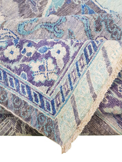 A handwoven Afghan Chobi rug featuring traditional Bidjar patterns in shades of blue and purple.