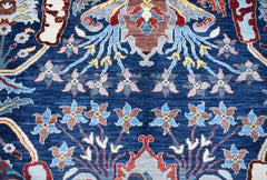 A handwoven Afghan Chobi rug featuring a traditional floral pattern in blue and earthy tones.