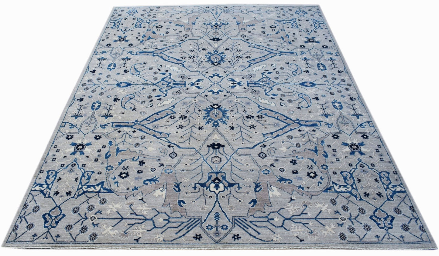 Handwoven Afghan Chobi rug featuring a traditional blue and grey floral pattern on a light base.