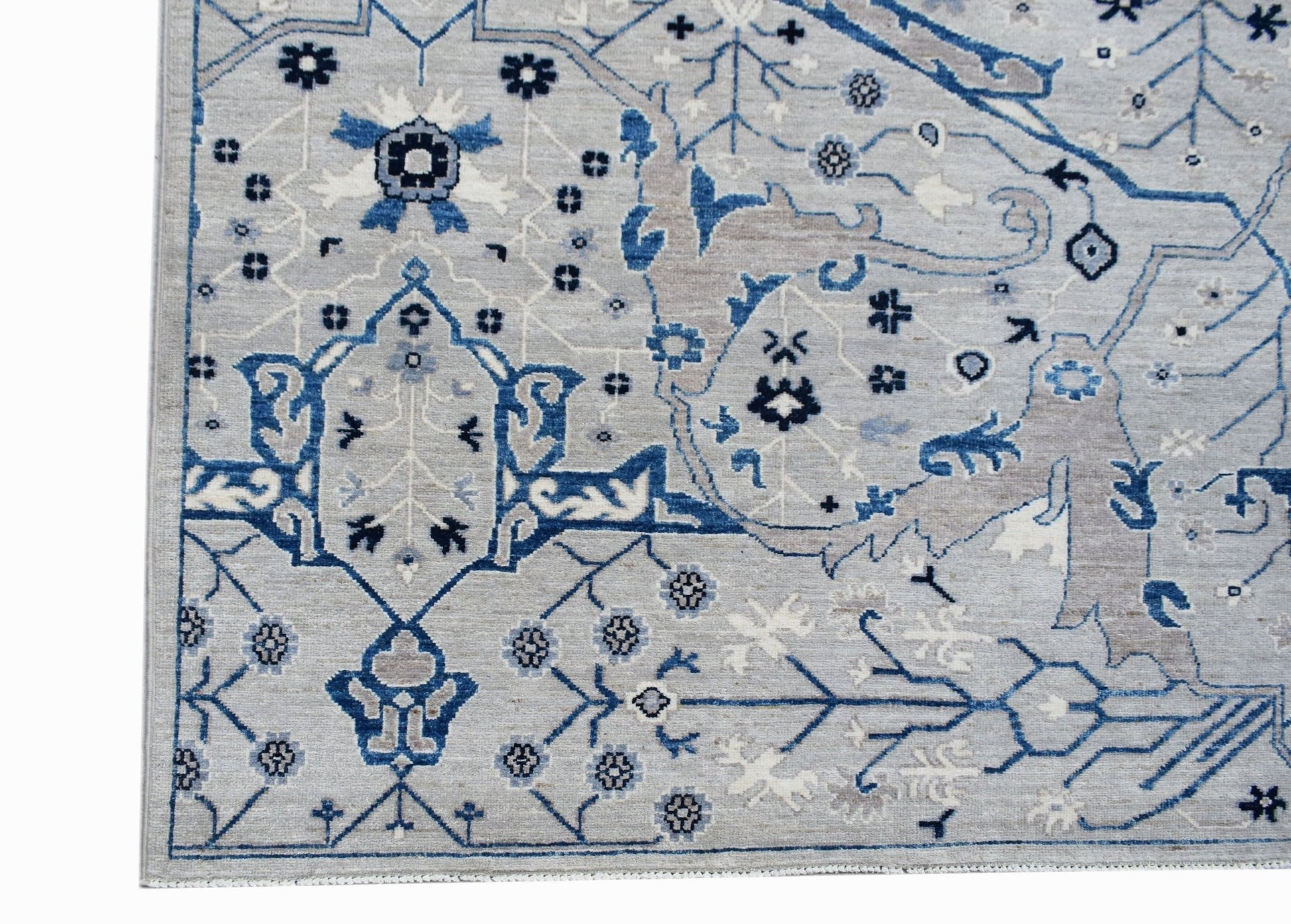 A handmade Afghan Chobi rug featuring a traditional Bidjar pattern in shades of blue and grey.