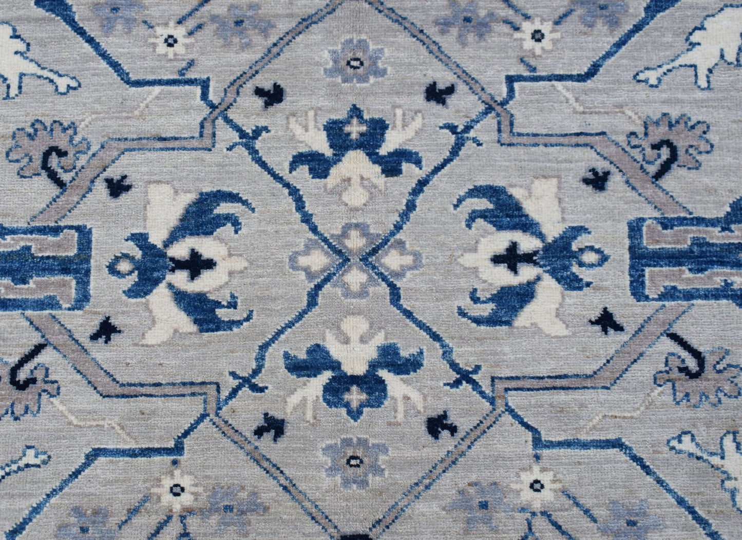 Handwoven Afghan Chobi rug featuring a traditional blue and grey geometric floral pattern.