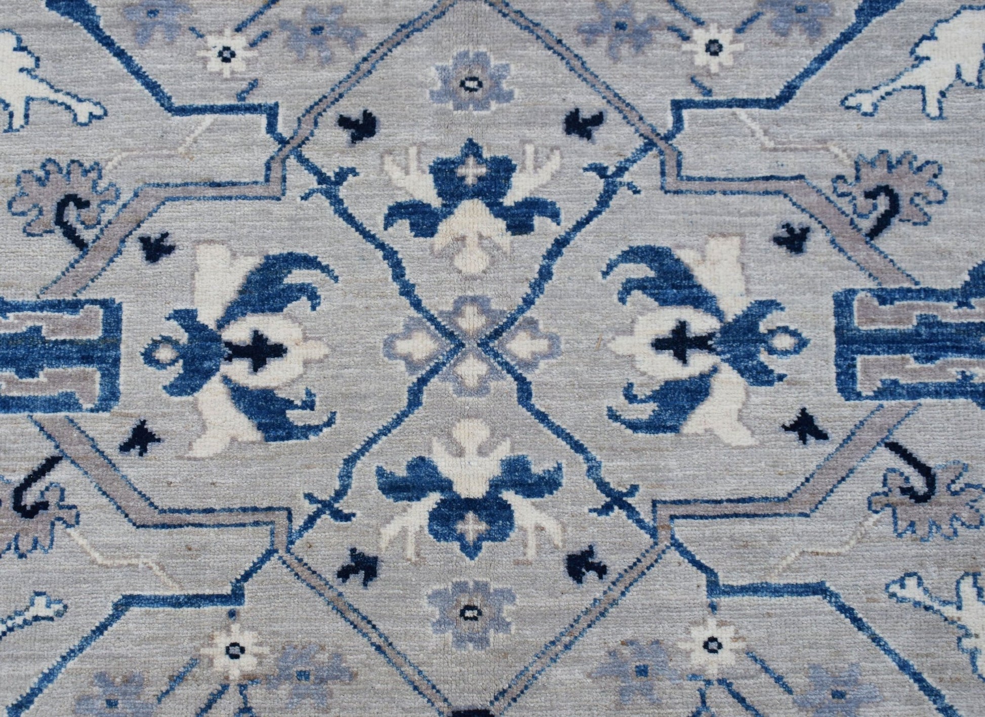 Handwoven Afghan Chobi rug featuring a traditional blue and grey geometric floral pattern.