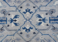 Handwoven Afghan Chobi rug featuring a traditional blue and grey geometric floral pattern.