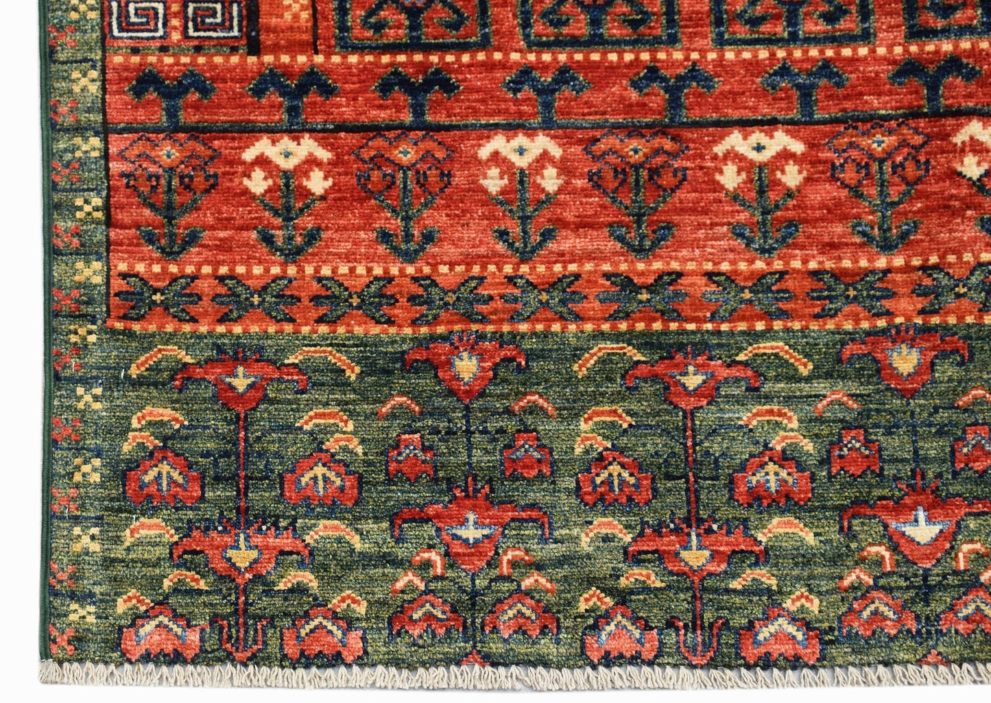 A handwoven Afghan Chobi rug featuring intricate floral patterns in red, green, and blue tones.