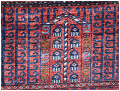 A handmade Afghan Chobi rug featuring a traditional red and blue geometric Engsi pattern.