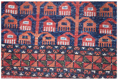 A close-up of an Afghan Chobi rug featuring intricate geometric patterns in red, blue, and ivory.