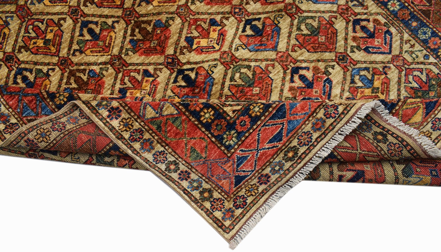 A handwoven Afghan Chobi rug featuring a geometric pattern in red, blue, and earthy tones.