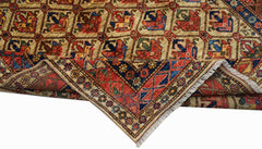 A handwoven Afghan Chobi rug featuring a geometric pattern in red, blue, and earthy tones.