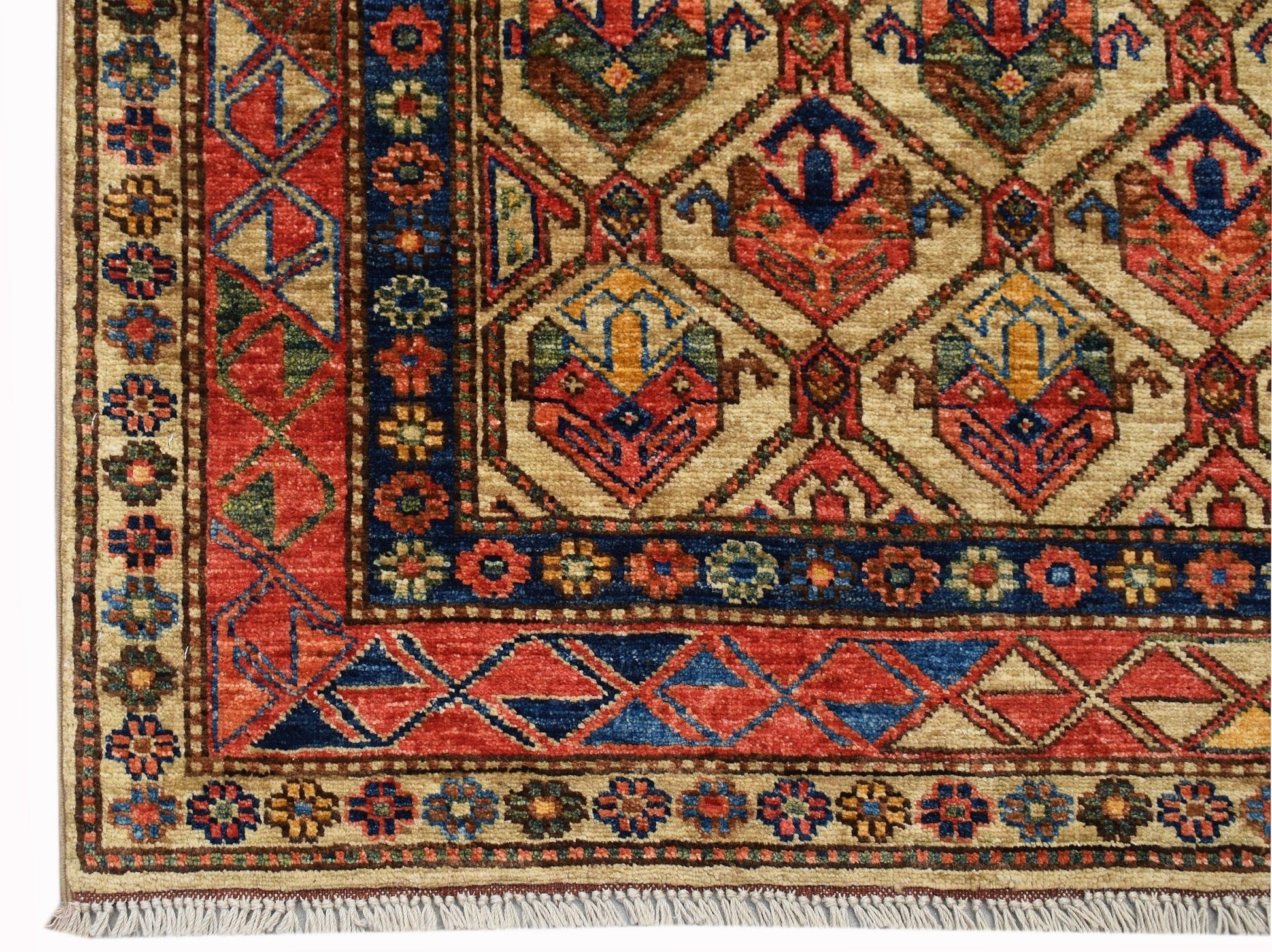 Handwoven Afghan Chobi rug featuring a geometric pattern in red, blue, and ivory with fringe.