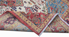 A handwoven Afghan Chobi rug featuring a traditional Heriz pattern in red, blue, and cream tones.