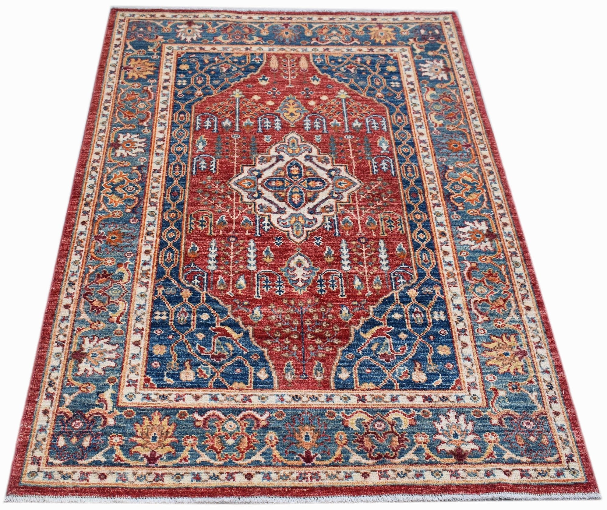 Handmade Afghan Chobi rug featuring a traditional Heriz pattern in red and blue wool.