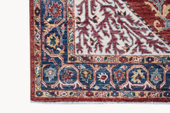 A handmade Afghan Chobi rug featuring a traditional Heriz pattern in red, blue, and cream tones.