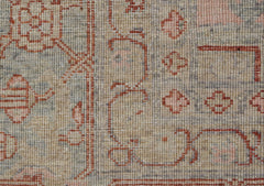 A close-up of a handwoven Afghan Chobi rug featuring traditional Heriz patterns in muted tones.