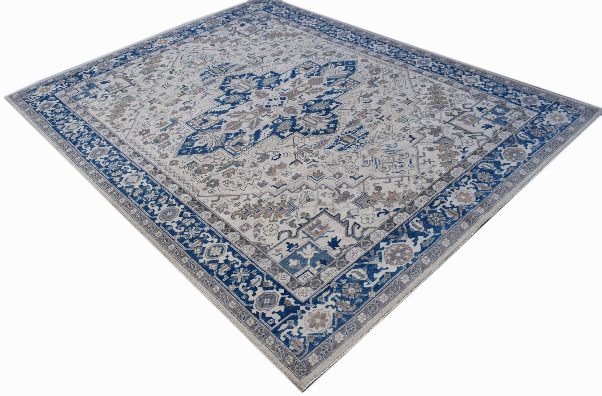 A rectangular Afghan Chobi rug featuring a traditional Heriz pattern in blue, beige, and grey.