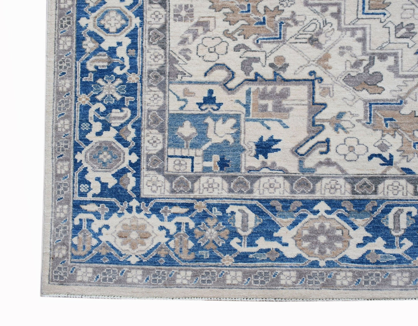 A handmade Afghan Chobi rug featuring a traditional Heriz pattern in blue, beige, and grey tones.