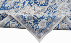 A handwoven Afghan Chobi rug featuring a traditional Heriz pattern in blue, beige, and grey.