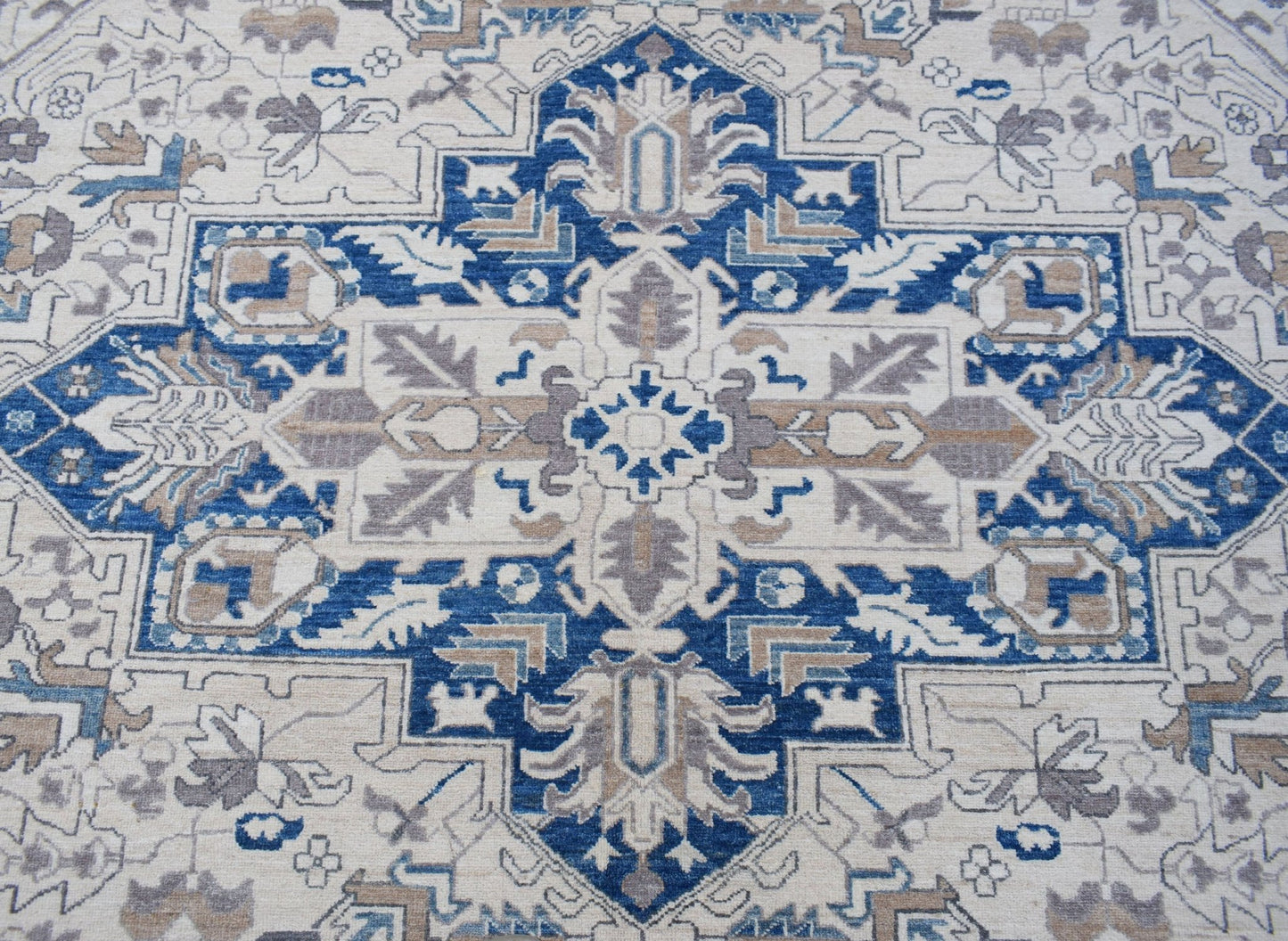 A handwoven Afghan Chobi rug featuring a traditional Heriz pattern in blue, beige, and grey.