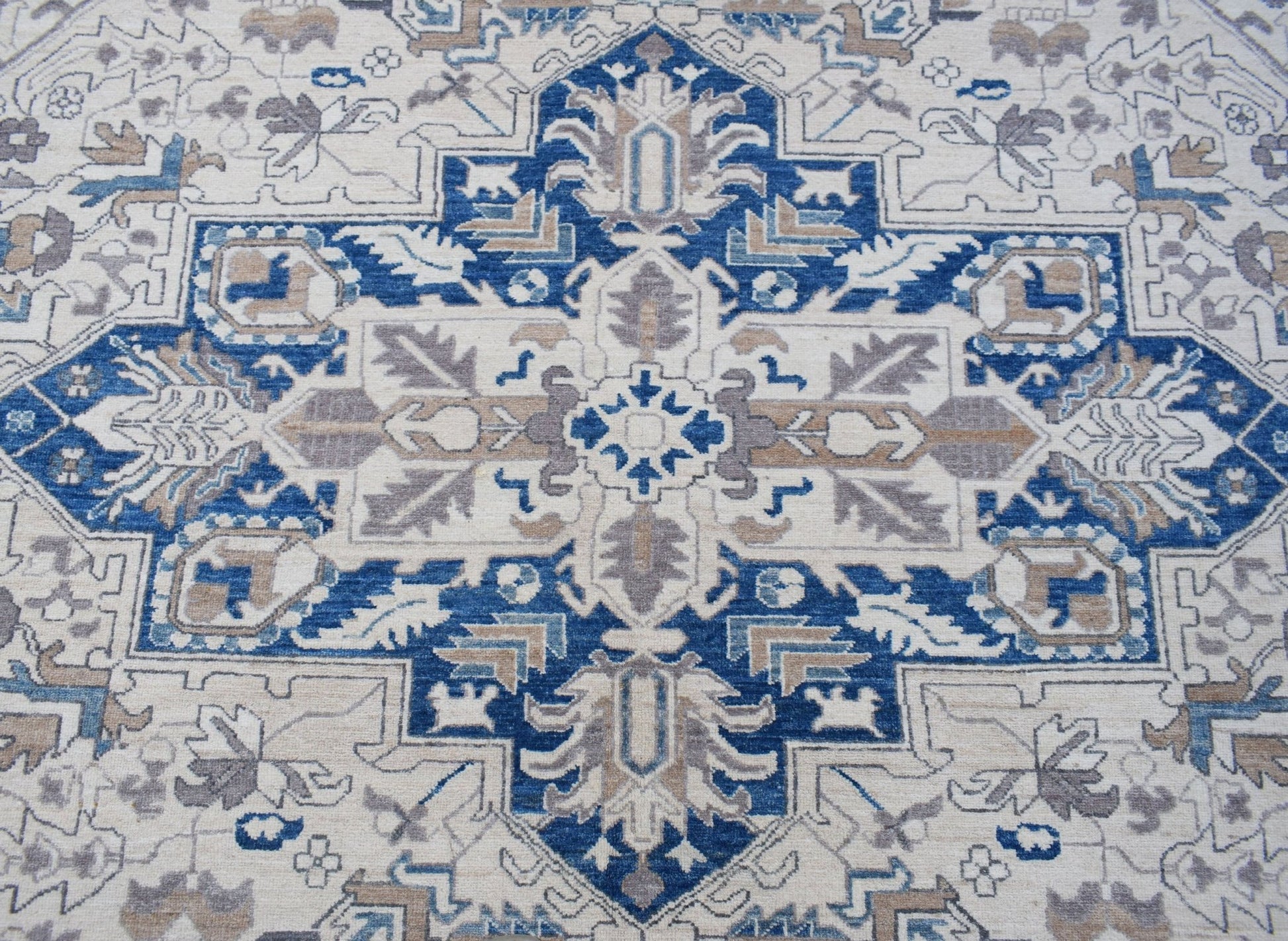 A handwoven Afghan Chobi rug featuring a traditional Heriz pattern in blue, beige, and grey.
