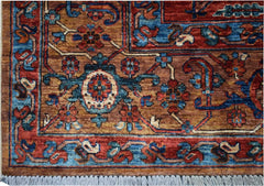 Handmade Afghan Chobi rug featuring a geometric Heriz pattern in rust, blue, and brown tones.
