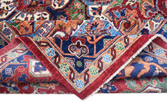 A handwoven Afghan Chobi rug featuring a traditional Heriz pattern in red, blue, and earthy tones.