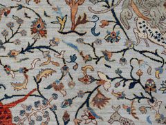 Handwoven Afghan Chobi rug featuring a detailed hunting scene with floral motifs on a light field.