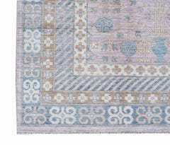 A handmade Afghan Chobi rug featuring a lavender field with blue pomegranate motifs and borders.