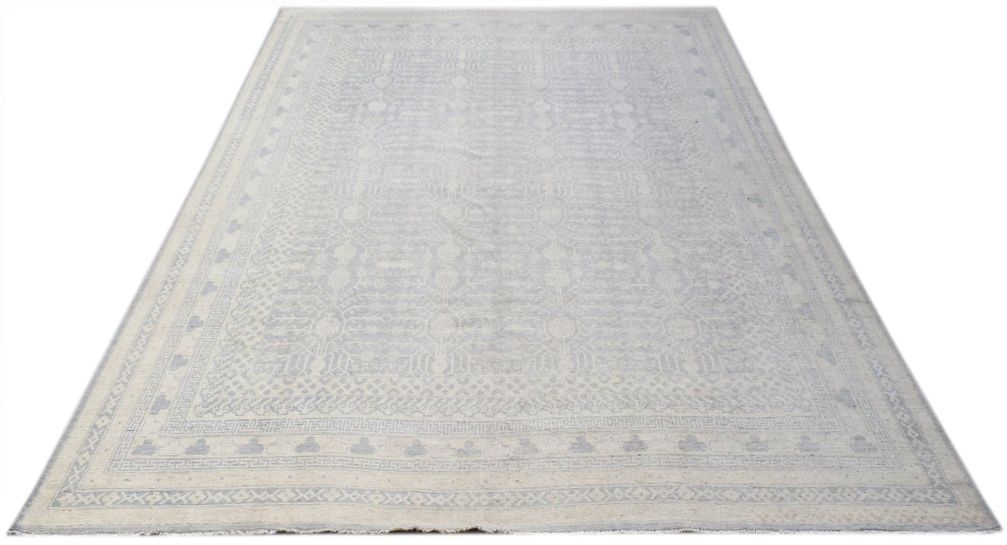 A handwoven Afghan Chobi rug featuring a light grey and cream Khotan pattern.