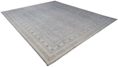 An Afghan Chobi rug with a light blue and cream traditional Khotan pattern.