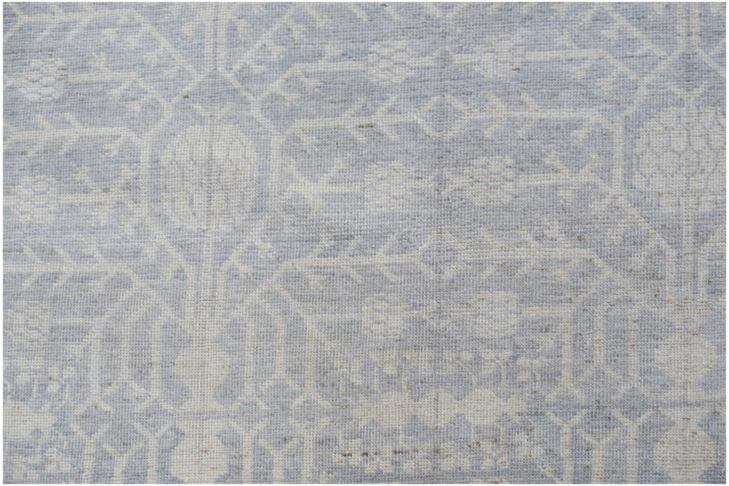 A handwoven Afghan Chobi rug featuring a light blue and cream traditional Khotan pattern.