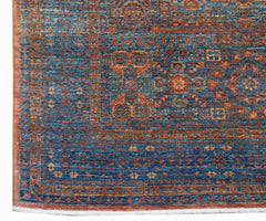 A handmade Afghan Chobi rug featuring a traditional blue and rust Mamluk medallion pattern.