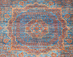 A handmade Afghan Chobi rug featuring a detailed blue and rust-colored Mamluk medallion pattern.