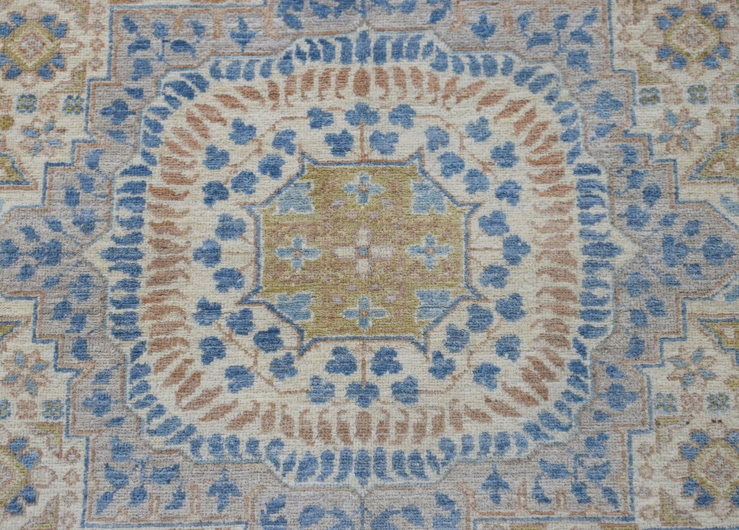 A handmade Afghan Chobi rug featuring a detailed Mamluk medallion in blue, tan, and cream tones.