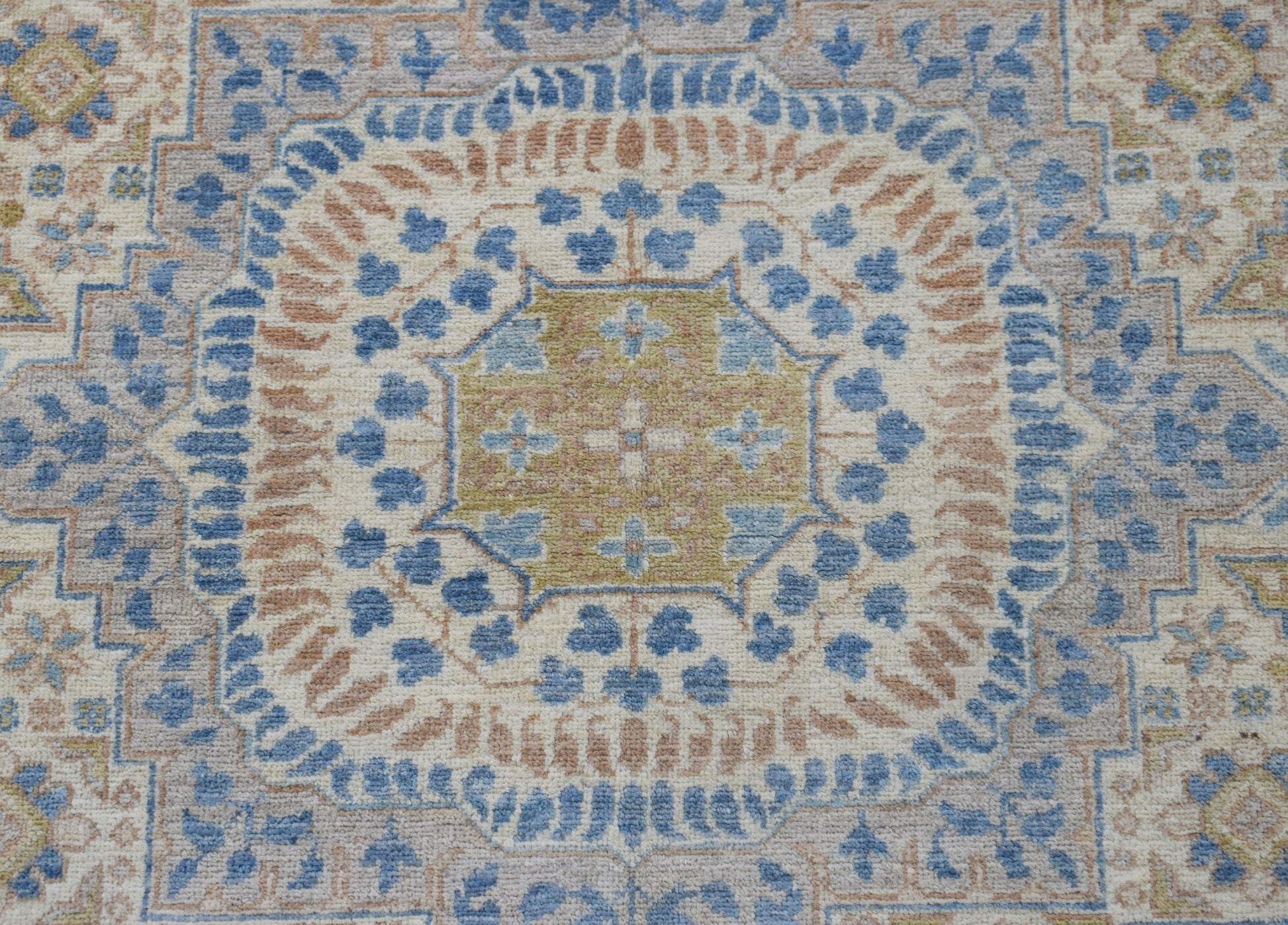 A handmade Afghan Chobi rug featuring a detailed Mamluk medallion in blue, tan, and cream tones.