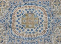 A handmade Afghan Chobi rug featuring a detailed Mamluk medallion in blue, tan, and cream tones.