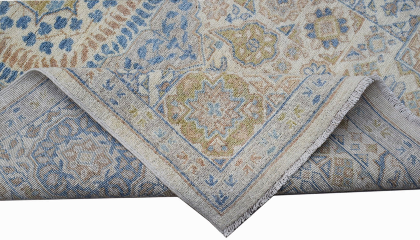 A handwoven Afghan Chobi rug featuring a traditional Mamluk medallion pattern in blue and tan.