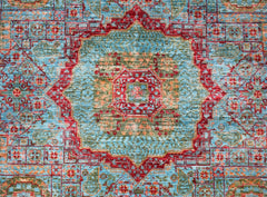 Handwoven Afghan Chobi rug featuring a detailed red and blue Mamluk medallion pattern.