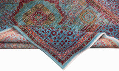 A handwoven Afghan Chobi rug featuring a blue field with a detailed red Mamluk medallion pattern.