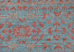 A close-up of a handwoven Afghan Chobi rug featuring a detailed Mamluk pattern in blue and red.