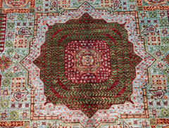 Handwoven Afghan Chobi rug featuring a detailed red and green Mamluk medallion pattern.