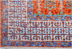 A handmade Afghan Chobi rug featuring a geometric Mamluk pattern in orange, blue, and cream.