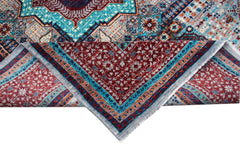 A handmade Afghan Chobi rug featuring a detailed Mamluk medallion pattern in red and blue tones.