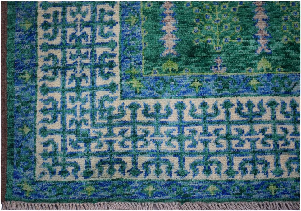 A handmade Afghan Chobi rug featuring a geometric Mamluk pattern in shades of blue and green.