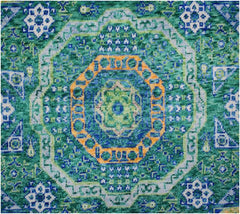 Handmade Afghan Chobi rug featuring a complex geometric medallion in shades of green and orange.