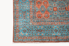 A handmade Afghan Chobi rug featuring a detailed Mamluk pattern in shades of blue and rust.