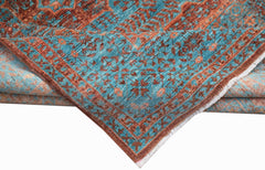 A handwoven Afghan Chobi rug featuring a detailed Mamluk pattern in teal and rust tones.