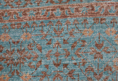A close-up of a handmade Afghan Chobi rug featuring a detailed Mamluk pattern in blue and brown.