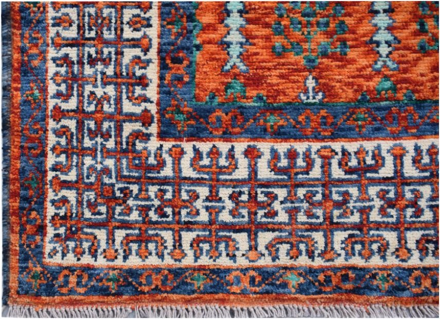 A handmade Afghan Chobi rug featuring a geometric Mamluk pattern in orange, blue, and cream.